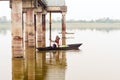 Kerala, India, January 10, 2018 Ã¢â¬â A local Active senior Man rowing his boat away from shore at a Kerala backwater area on sunset Royalty Free Stock Photo