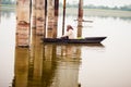 Kerala, India, January 10, 2018 Ã¢â¬â A local Active senior Man rowing his boat away from shore at a Kerala backwater area on sunset Royalty Free Stock Photo