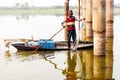 Kerala, India, January 10, 2018 Ã¢â¬â A local fisherman fishing with his fishing net on a rowing boat at a Kerala backwater area at Royalty Free Stock Photo