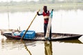 Kerala, India, January 10, 2018 Ã¢â¬â A local fisherman fishing with his fishing net on a rowing boat at a Kerala backwater area at Royalty Free Stock Photo