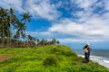 Solo girl traveler standing on a cliff at a beach town called Varkala in Kerala, India Royalty Free Stock Photo