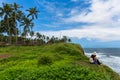 Solo girl traveler standing on a cliff at a beach town called Varkala in Kerala, India Royalty Free Stock Photo