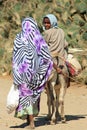 Young Eritrean girl riding a donkey with her mother, Keren, Eritrea
