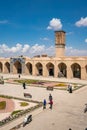 Kerman, Iran - 19.04.2019: People walking around and sitting in the square and bazaar crossroads in the city of Kerman