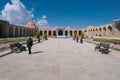 Kerman, Iran - 19.04.2019: People walking around and sitting in the square and bazaar crossroads in the city of Kerman