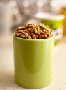 Kernel walnuts in a green cup