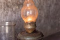 Kerosene lamp burning on a gray wall background Royalty Free Stock Photo