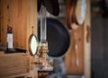 Kerosene lamp hangs on a wooden wall in a farmhouse