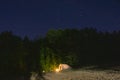 Kerosene lamp by the lake. Camping and the stars sky