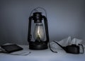 Kerosene lamp, oiler, a notebook on table in the twilight