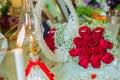Red ribbon . Red engagement flowers on white table . Bride and groom with Engagement gold rings put on the red wedding bouquet . Royalty Free Stock Photo