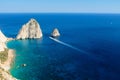 Kerri cliffs and a motorboat between two Mezithres. Zakynthos, Greece.