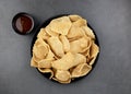 Kerupuk udang - traditional indonesian shrimp crackers on a gray background with sweet chili sauce.