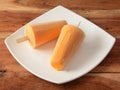 Kesar kulfi served in white plate over a rustic wooden background, selective focus Royalty Free Stock Photo