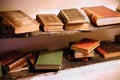 Keswick, Cumbria, UK - April 6th 2019: Selection of very old antique books, some leather bound, on old wooden shelves Royalty Free Stock Photo