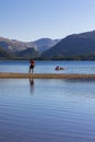 KESWICK,ENGLAND - AUGUST 10 2023 - Swimmers and bathers in Derwentwater at the town of Keswick in the Lake District National Park