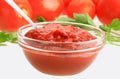 Ketchup in glass dish on background of red tomatos Royalty Free Stock Photo