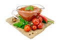 Ketchup in a glass gravy boat with vegetables on sacking Royalty Free Stock Photo