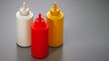 Ketchup, mayonnaise and mustard bottles isolated on gray background. 3D illustration