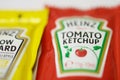 Ketchup and mustard from Heinz brand in sachets Royalty Free Stock Photo