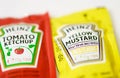 Ketchup and mustard from Heinz brand in sachets Royalty Free Stock Photo