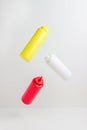 Ketchup, mustard, mayonnaise bottles. Levitation. Food design. Mock-up Royalty Free Stock Photo