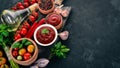 Ketchup sauce in a bowl. Cherry tomatoes, spices, chili peppers, olive oil, parsley. Top view. Royalty Free Stock Photo