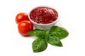 Ketchup tomato paste in a saucepan with basil leaves and whole tomatoes on a white background Royalty Free Stock Photo
