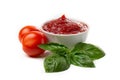 Ketchup tomato paste in a saucepan with basil leaves and whole tomatoes on a white background Royalty Free Stock Photo