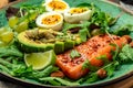 Keto bowl salmon salad with greens, eggs and avocado. Ketogenic diet breakfast lunch. Top view