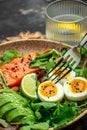 Keto bowl salmon salad with greens, eggs and avocado. Ketogenic diet breakfast lunch. vertical image. top view. place for text