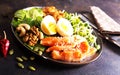 Keto bowl salmon salad with greens, eggs and nuts