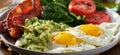 Keto breakfast plate with eggs bacon and mashed avocado Royalty Free Stock Photo