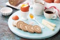 Keto carnivore diet breakfast. Soft-boiled eggs, liver roll pate with butter, goat cheese and coffee on a wooden plate