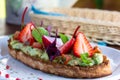 Keto diet avocado toast with strawberries, soft cheese, sesame seeds and herbs. healthy Breakfast or lunch. sandwich Royalty Free Stock Photo