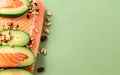 Keto diet concept. salmon, avocado, nuts and seeds, pastel green background, top view. Keto diet food ingredients. Generative AI Royalty Free Stock Photo