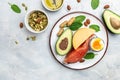 Keto diet food, salmon, avocado, cheese, egg, spinach and nuts. Ketogenic low carbs diet concept. Ingredients for healthy foods Royalty Free Stock Photo