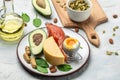 Keto diet food, salmon, avocado, cheese, egg, spinach and nuts. Ketogenic low carbs diet concept. Ingredients for healthy foods Royalty Free Stock Photo