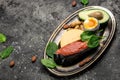 Keto diet food, salmon, avocado, cheese, egg, spinach and nuts. Ketogenic low carbs diet concept. Ingredients for healthy foods Royalty Free Stock Photo