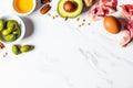 Keto diet ingredients frame on white marble background, copy space. Low carbohydrate menu concept Royalty Free Stock Photo