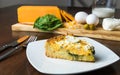Keto homemade goat cheese and spinach pie with table settings. Close up Royalty Free Stock Photo