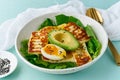 keto ketogenic diet soft boiled eggs with avocado and lettuce on pastel background closeup Royalty Free Stock Photo