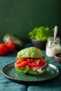 Keto paleo diet avocado burger with bacon, lettuce, tomato