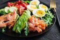 Ketogenic diet breakfast. Salt salmon salad with boiled shrimps, prawns, tomatoes, spinach, eggs and avocado. Royalty Free Stock Photo