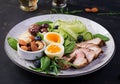 Ketogenic diet. Keto brunch. Boiled egg, pork steak and olives, cucumber, spinach, brie cheese, nuts and blueberry Royalty Free Stock Photo