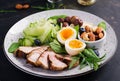 Ketogenic diet. Keto brunch. Boiled egg, pork steak and olives, cucumber, spinach, brie cheese, nuts and blueberry Royalty Free Stock Photo