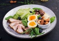 Ketogenic diet. Keto brunch. Boiled egg, pork steak and olives, cucumber, spinach, brie cheese, nuts and blueberry Royalty Free Stock Photo