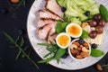 Ketogenic diet. Boiled egg, pork steak and olives, cucumber, spinach, brie cheese, nuts and blueberry. Top view Royalty Free Stock Photo