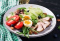 Ketogenic diet. Boiled egg, pork steak and olives, cucumber, spinach, brie cheese, nuts and tomato Royalty Free Stock Photo