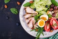 Ketogenic diet. Boiled egg, pork steak and olives, cucumber, spinach, brie cheese, nuts and tomato. Top view Royalty Free Stock Photo